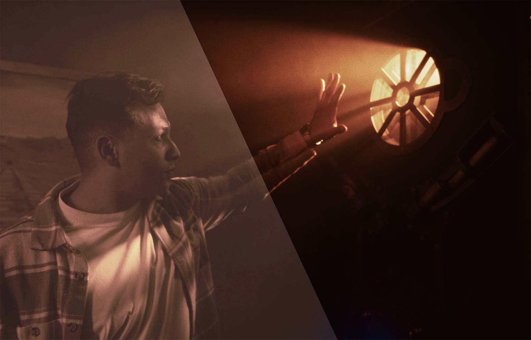 On set: a performer reaches toward a film light